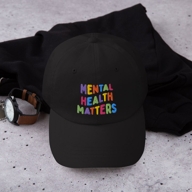 Black dad hat with Mental Health Matters embroidered in colorful letters.