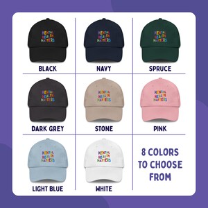 Grid to show color options of 8 dad hats with Mental Health Matters embroidered in colorful letters. The color options are black, navy, spruce, dark grey, stone, pink, light blue, and white.