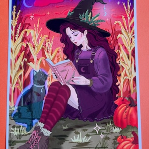 May include: An illustration of a witch reading a book with the title "Magic". She wears a black witch hat, purple dress, and burgundy striped socks. A black cat with a crescent moon collar sits beside her, and pumpkins are in the background.