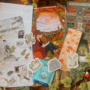 May include: A collection of stationery items themed around an enchanted forest, including a letter, a printed illustration of a person drawing in a landscape, sticker sheets with mushroom and woodland motifs, a bookmark, and a tea bag.