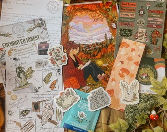 May include: A collection of stationery items themed around an enchanted forest, including a letter, a printed illustration of a person drawing in a landscape, sticker sheets with mushroom and woodland motifs, a bookmark, and a tea bag.