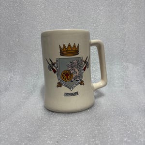 Ceramic souvenir mug featuring the coat of arms of Caracas. Caracas Venezuela