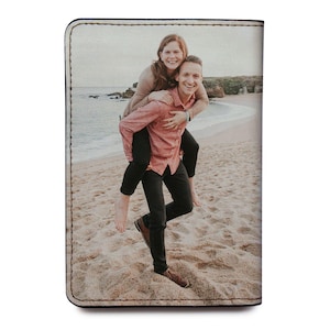 a couple of people that are standing in the sand