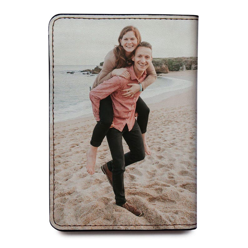 a couple of people that are standing in the sand