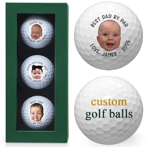 three golf balls with personalized messages on them. The first golf ball has a picture of a baby, the second golf ball has a picture of a father, and the third golf ball has a picture of a baby. The golf balls are displayed in a green box, and the message "Best Dad by Par" is printed on them.