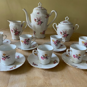 Limoges B et Cie porcelain coffee service circa 1965. 19 piece set in excellent condition. Hand painted with gold trim.
