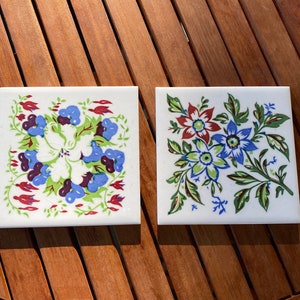 Pair of vintage painted Wheeling Cushion tiles. Gorgeous floral design.