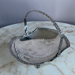 Antique Silver plated basket dish, circa late 1800s.Flower trim. Ornate English footing.
