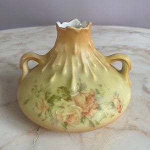 A late 19th/early 20th century transfer-printed bud vase with two handles and “drip” motif.  Marked 1857 on bottom of vase.