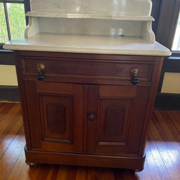 SOLD. 1870s to 1890s Victorian marble top walnut washstand or commode, with a handle for towels.