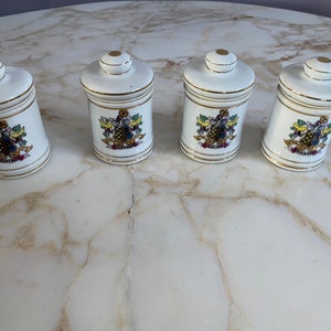 Vintage set of porcelain gold rimmed  Apothecary jars or pulvis jars with lids. Made in Japan mid century. Lovely set.
