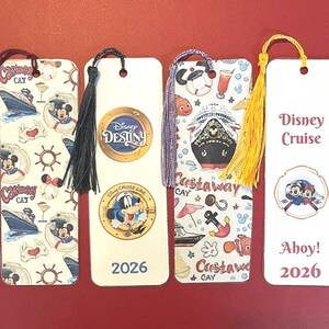 May include: Four rectangular bookmarks with tassels. The first features Castaway Cay and cruise ship motifs. The second shows the Disney Destiny logo and a character in a porthole with 2026. The third has cruise icons. The fourth says Disney Cruise Ahoy! 2026.