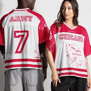 May include: Two short-sleeve jerseys with red and white color blocking. The left jersey features the text ARMY and the number 7. The right jersey displays the text CHICAGO and a graphic of a whale with the text Whale Tail Bulletproof.