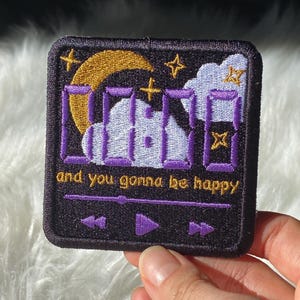 May include: Embroidered patch with a black background featuring a purple digital clock display showing "11:11", a gold crescent moon, stars, and a white cloud. The text "and you gonna be happy" is below the clock.