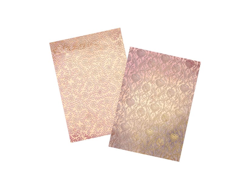 May include: Two sheets of decorative paper with a pink and gold floral pattern. The paper has a subtle shimmer and is perfect for crafting or scrapbooking.