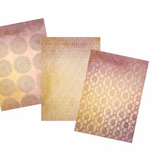 May include: Three decorative paper sheets with a gold and pink color scheme. Each sheet features a different intricate pattern.