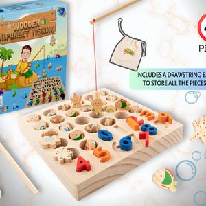 May include: Wooden alphabet fishing game with 40 pieces, including a drawstring bag. The game features a wooden board with holes for colorful fish and number pieces. A fishing rod is included. The box has a cartoon illustration.