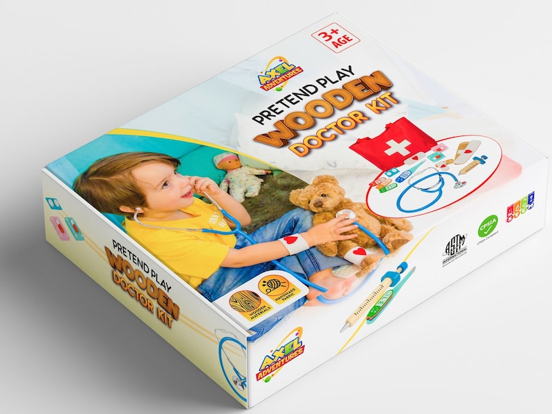 May include: A colorful box for a wooden doctor's kit for pretend play. The box features a child playing doctor with a teddy bear. The box is labeled "Pretend Play Wooden Doctor Kit" and "Axel Adventures".
