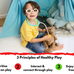 May include: A young child wearing a yellow shirt, blue jeans, and white glasses plays doctor with a teddy bear. The child is using a toy stethoscope to listen to the teddy bear's heart. The image includes the text "3 Principles of Healthy Play" with three numbered circles, each with a different principle: "Prioritize hands-on play", "Interact & connect through play", and "Enjoy screen free time".