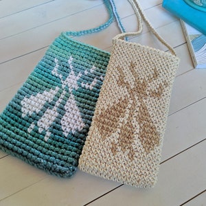May include: Two crocheted bags with adjustable straps. One bag is teal with a white design and the other is beige with a brown design.