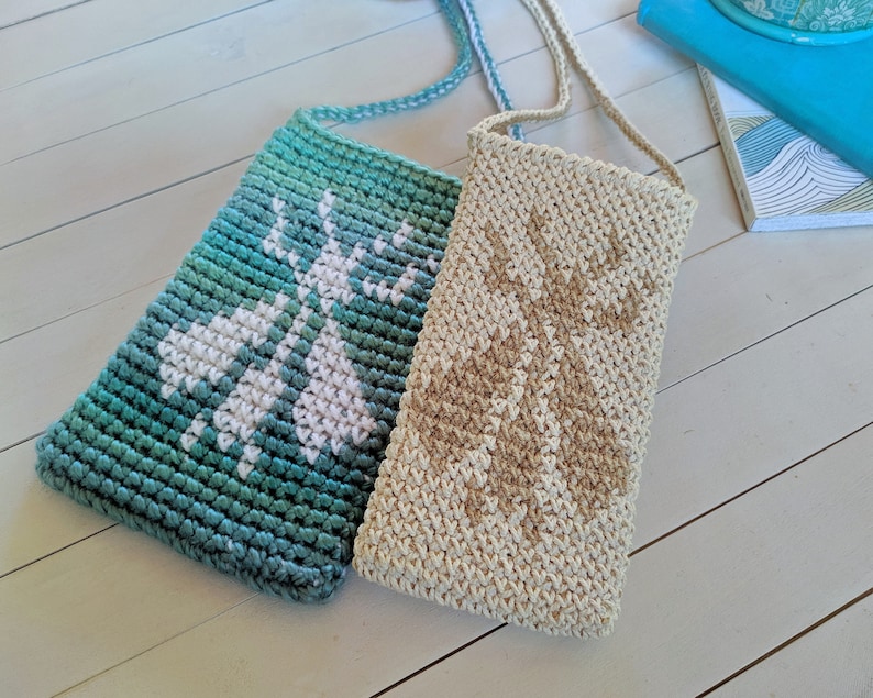 May include: Two crocheted bags with adjustable straps. One bag is teal with a white design and the other is beige with a brown design.