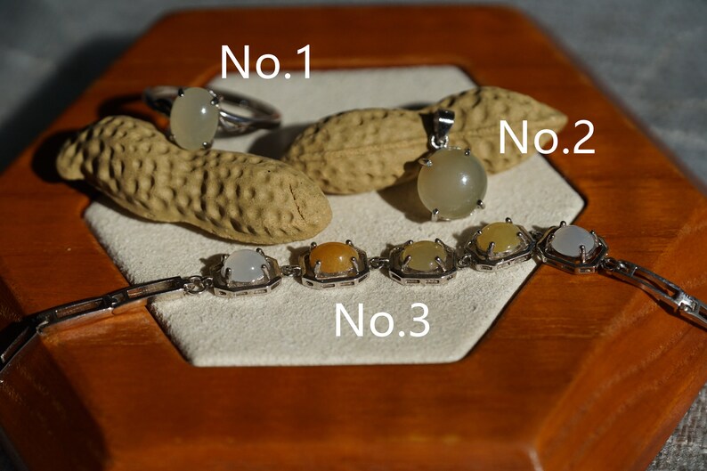 May include: Three silver jewelry pieces with white and yellow gemstones. The first piece is a ring labeled "No. 1", the second is a pendant labeled "No. 2", and the third is a bracelet labeled "No. 3".