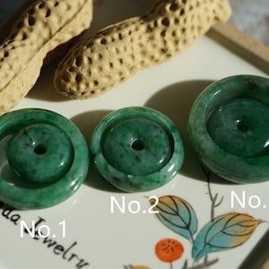 May include: Three jade green donut-shaped pendants with a hole in the center. The pendants are labeled No. 1, No. 2, and No. 3.