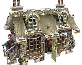 May include: A three-dimensional cardboard cottage with a thatched roof covered in snow. The structure features stone walls, multiple windows, a green door, and a Santa Claus figure carrying a tree. Small potted trees and a squirrel are visible.