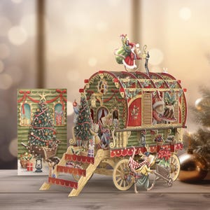 May include: A 3D pop-up Christmas card featuring a red and green wagon with a decorated Christmas tree inside. The wagon is pulled by a group of mice and has a red roof with a white star. The card is decorated with holly and other festive details.