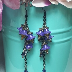 Handmade long chain dangle earrings with multi small purple flowers with yellow crystal centres and deep purple crystal droplets. Black chain and earring hooks. Bohemian Witchy Jewellery, Gift for goth, Gothic Floral Dangles,