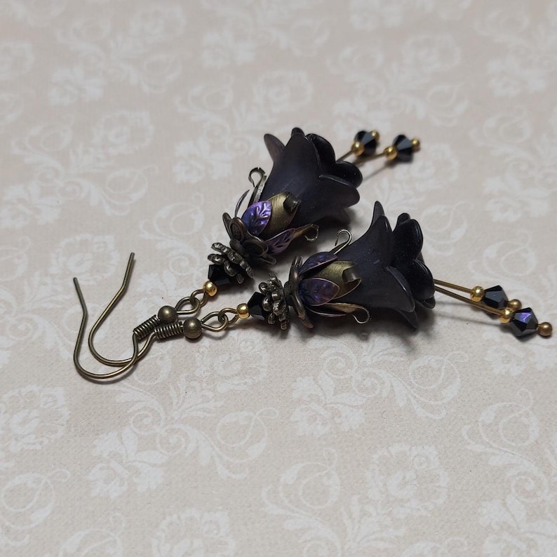 Gothic black double flower earrings, double bell flower have been combined with antique bronze floral bead caps for an art nouveau feel, jet black crystal drops hang from under the flowers to add sparkle. Gothic fairy jewellery, Earring gift for her.