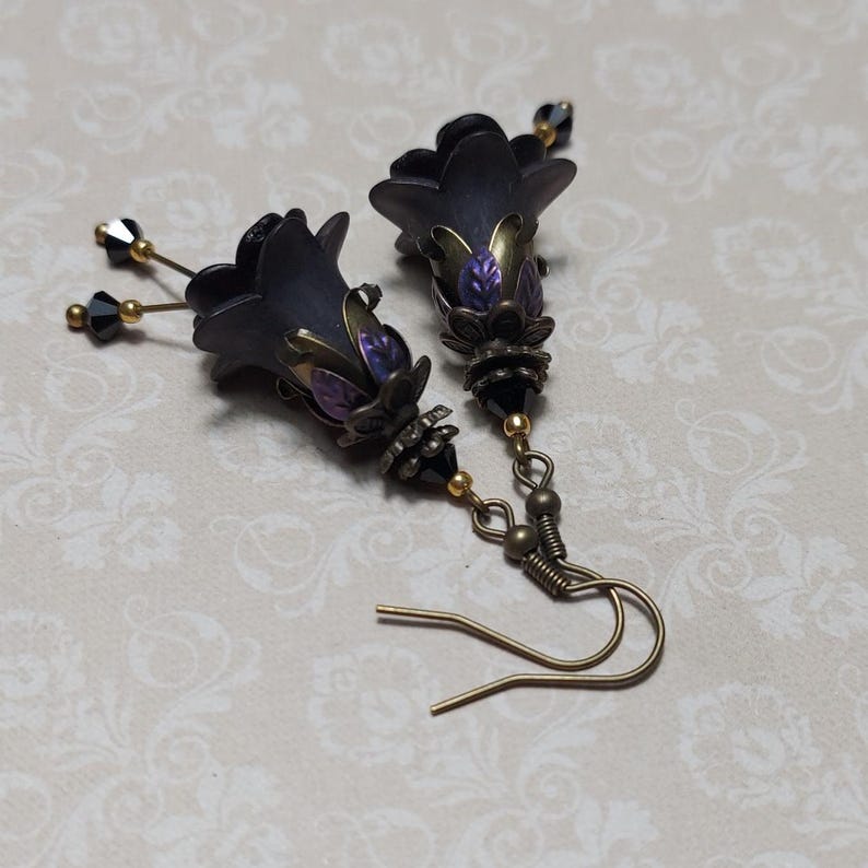 Gothic black double flower earrings, double bell flower have been combined with antique bronze floral bead caps for an art nouveau feel, jet black crystal drops hang from under the flowers to add sparkle. Gothic fairy jewellery, Earring gift for her.