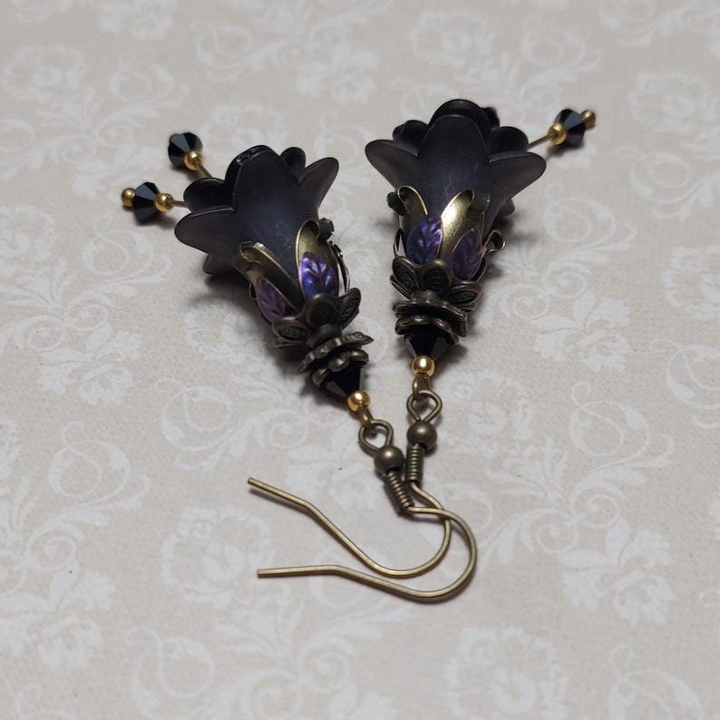 Gothic black double flower earrings, double bell flower have been combined with antique bronze floral bead caps for an art nouveau feel, jet black crystal drops hang from under the flowers to add sparkle. Gothic fairy jewellery, Earring gift for her.