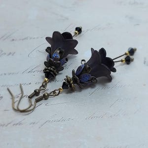 Gothic black double flower earrings, double bell flower have been combined with antique bronze floral bead caps for an art nouveau feel, jet black crystal drops hang from under the flowers to add sparkle. Gothic fairy jewellery, Earring gift for her.