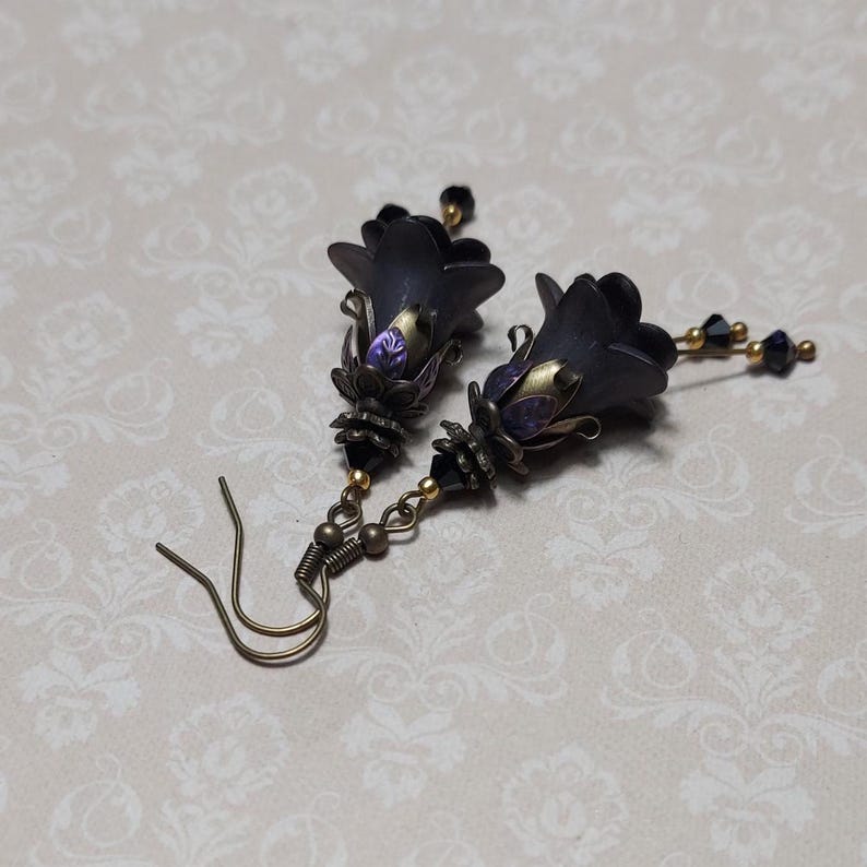 Gothic black double flower earrings, double bell flower have been combined with antique bronze floral bead caps for an art nouveau feel, jet black crystal drops hang from under the flowers to add sparkle. Gothic fairy jewellery, Earring gift for her.
