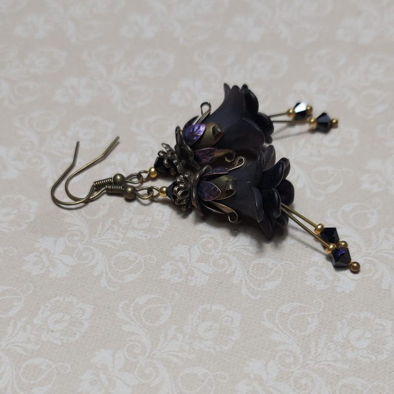 Gothic black double flower earrings, double bell flower have been combined with antique bronze floral bead caps for an art nouveau feel, jet black crystal drops hang from under the flowers to add sparkle. Gothic fairy jewellery, Earring gift for her.