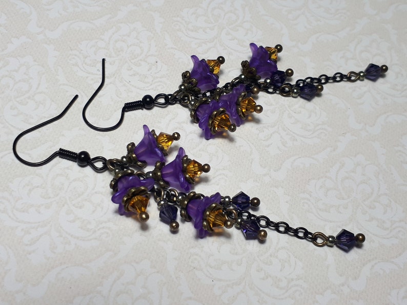 Handmade long chain dangle earrings with multi small purple flowers with yellow crystal centres and deep purple crystal droplets. Black chain and earring hooks. Bohemian Witchy Jewellery, Gift for goth, Gothic Floral Dangles,