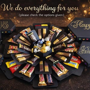 May include: A black explosion box with chocolate bars, candies, and a heart-shaped card. The box is decorated with gold lettering that says "We do everything for you", "Happy", and "Anniversary". Other boxes say "45 years".