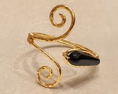 Bracelet in wrought copper bathed in gold, with double spiral and black agate stone