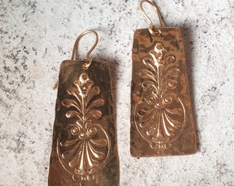 Antique style hammered plaque earrings with a palmette floral decoration. Craftsmanship.