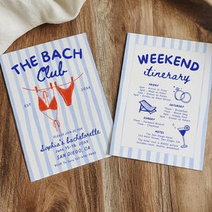 May include: Two invitation cards on a wooden tray. One card reads "THE BACH Club" with a bikini graphic. The other card says "WEEKEND itinerary" with a schedule and illustrations. Both cards have blue and white stripes.