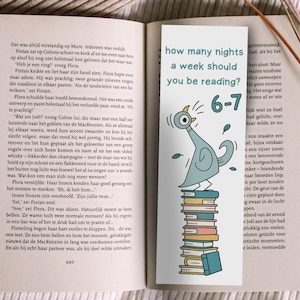 May include: A bookmark with the text "how many nights a week should you be reading?" and the numbers "6-7". A cartoon pigeon stands on a stack of books. The bookmark is in an open book.