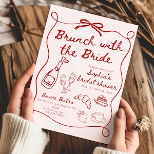 May include: A red and white bridal shower invitation with the text "Brunch with the Bride" and "Sophia's bridal shower". The invitation includes details for the event, including the date, time, and location. The invitation also features a red illustration of a champagne bottle, two champagne flutes, a croissant, a slice of cake, a strawberry, and a cup of coffee.
