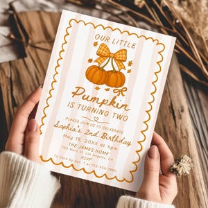 May include: A birthday invitation with a pumpkin theme. The card features text that reads "Our Little Pumpkin is Turning Two" and includes details for Sophia's 2nd birthday. The design includes pumpkins and a bow.