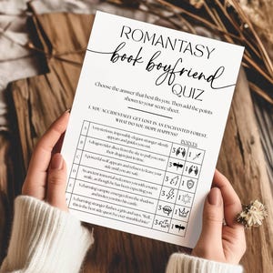 May include: A white rectangular paper sheet titled Romantasy Book Boyfriend Quiz with black text and icons. The quiz features a multiple-choice question about getting lost in an enchanted forest, with options A through F, point values, and small black graphic symbols for each choice.