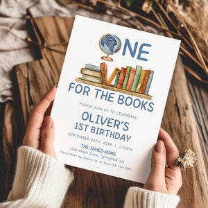 May include: A white invitation card with blue and brown text. The card features a watercolor illustration of a stack of books and a globe. The text reads "One for the Books, Please join us to celebrate Oliver's 1st Birthday, September 23th, 20XX | 2:30PM, The James Home, 1234 Maple Street, Springfield, CA, Please RSVP by August 1st to Sara 123-456-7890".
