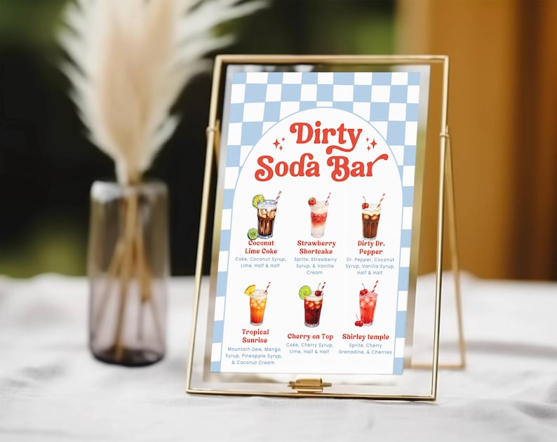 May include: A gold-framed sign with a blue and white checkered background displays a "Dirty Soda Bar" menu. The menu features six colorful soda drink illustrations with their ingredients listed below each drink.