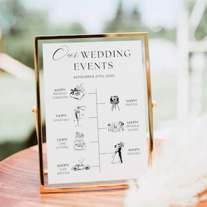 May include: A gold-framed wedding events sign with the text "Our WEDDING EVENTS" and a schedule for September 27th, 20XX. The schedule includes times for the ceremony, photos, cocktails, cake cutting, dinner, toasts, and dancing.