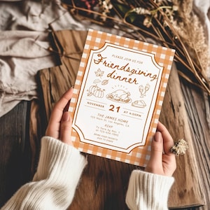 May include: A rectangular Friendsgiving dinner invitation card with an orange and white gingham border. The center features brown line art of pumpkins, a turkey, and wine glasses, with text including November 21 at 4:00PM, The James Home, and RSVP details.
