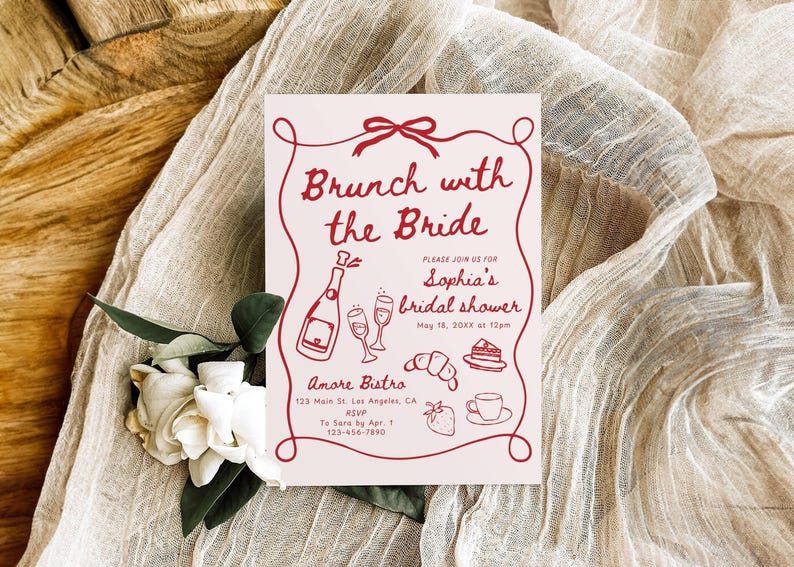 May include: A red and white bridal shower invitation with the text "Brunch with the Bride" and "Sophia's bridal shower". The invitation includes a drawing of a bottle of champagne, two champagne flutes, a croissant, a slice of cake, and a strawberry.